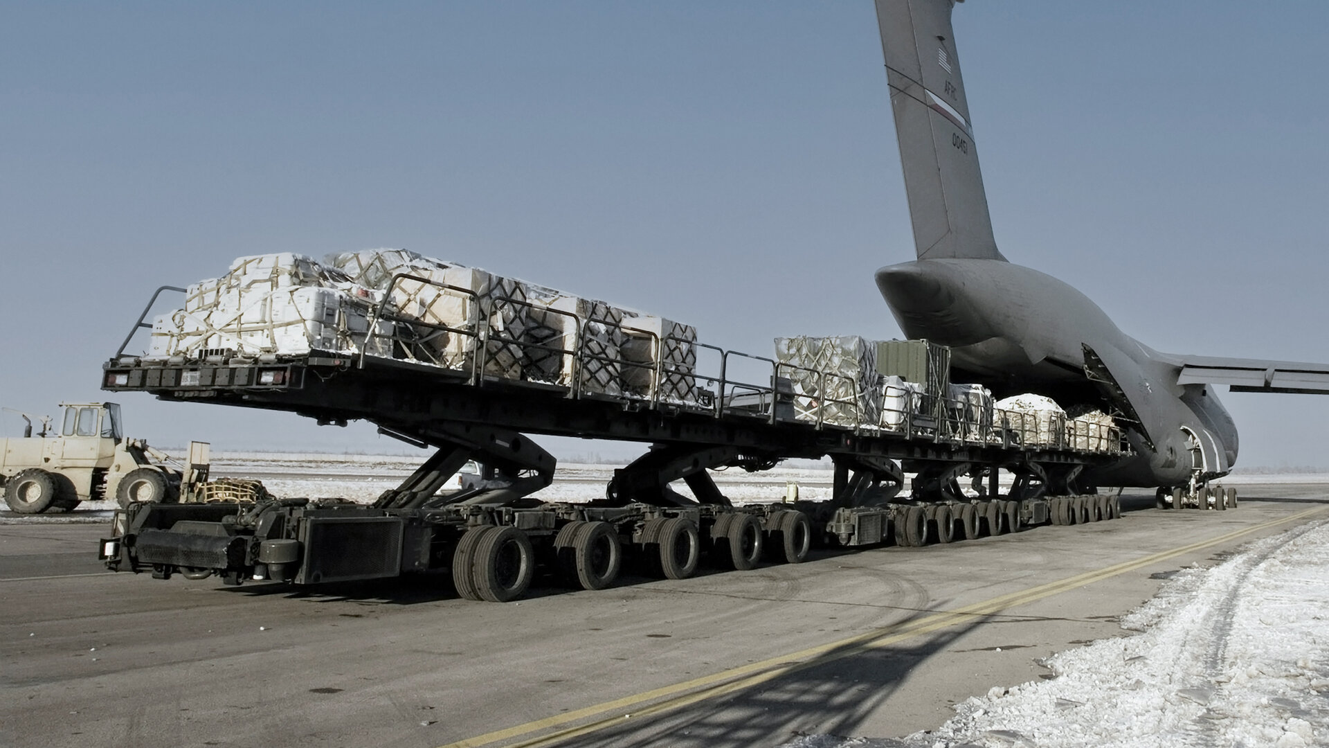 military transport jet loading cargo